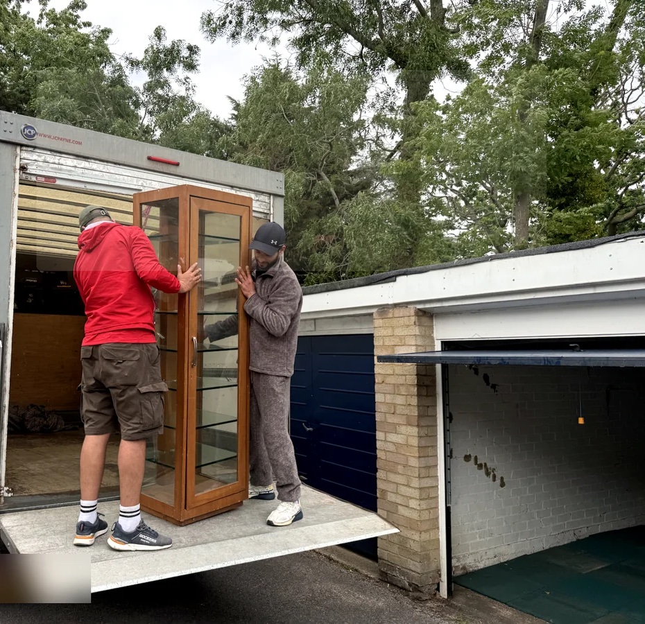 Two ZippyVan movers carrying furniture during a home move